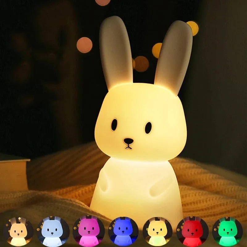 Rabbit-shaped night light with color-changing options on a dark background