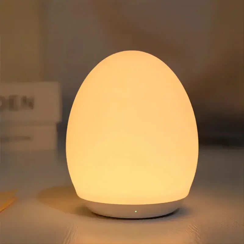 Egg-shaped lamp emitting a warm glow on a blurred background