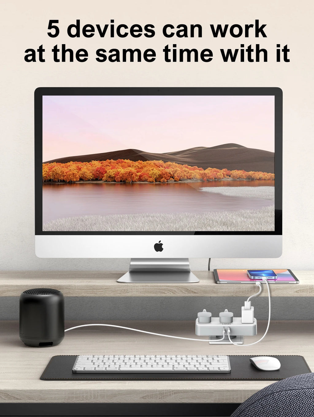 Computer setup with multiple devices on a desk, including a monitor, keyboard, mouse, and speakers.