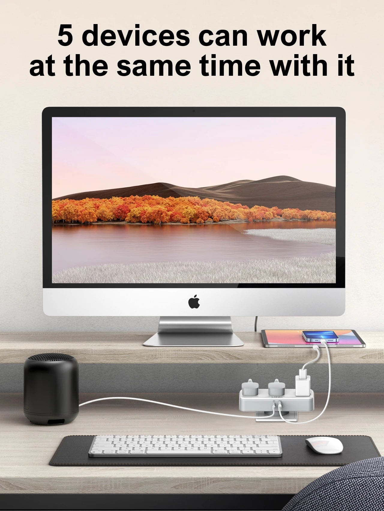 Computer setup with multiple devices on a desk, including a monitor, keyboard, mouse, and speakers.