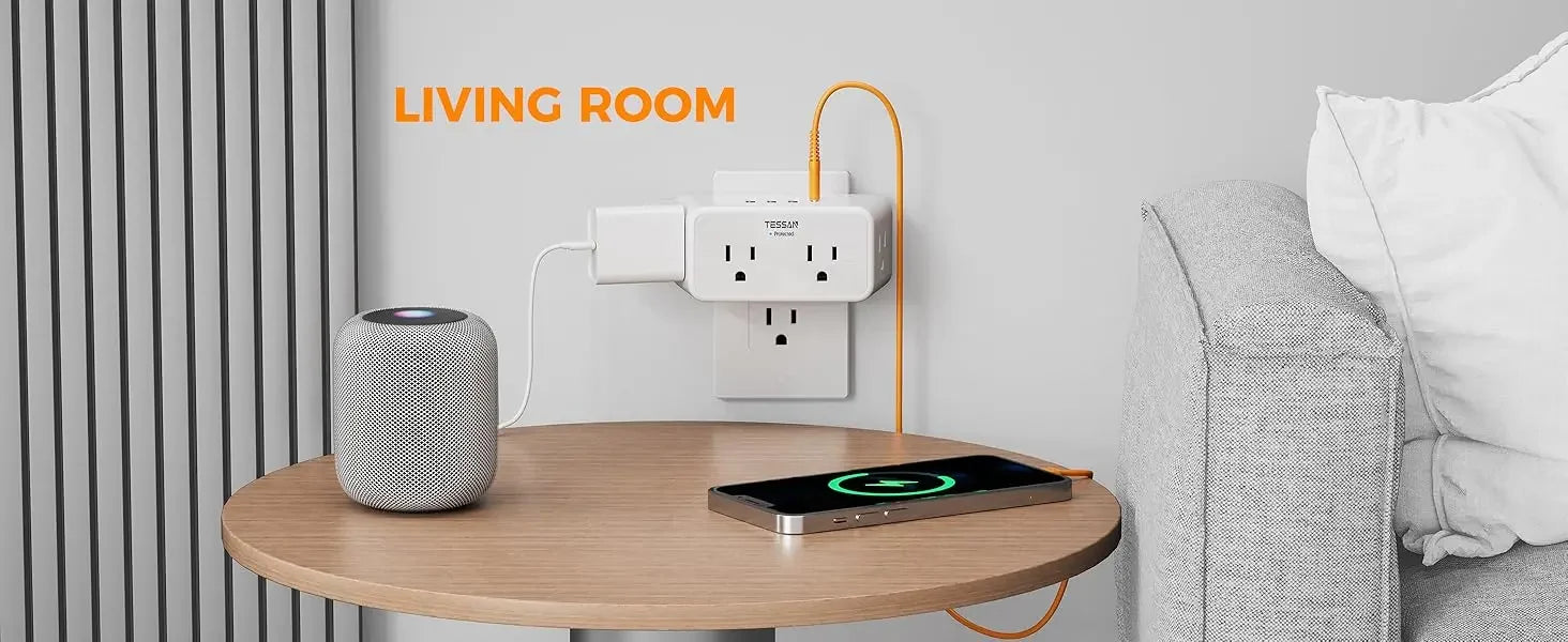 Living room setting with a round wooden table, smartphone on a wireless charger, and a speaker.