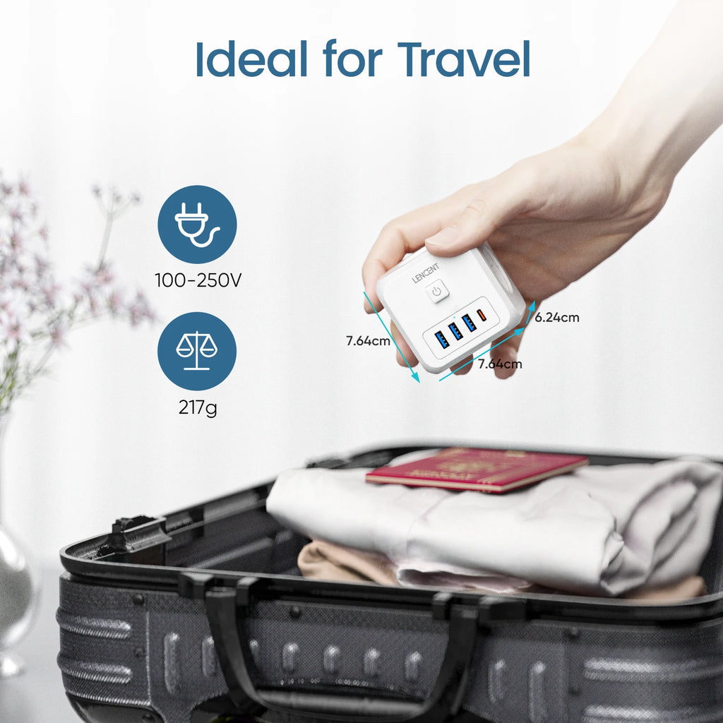 Hand holding a white USB adapter with specifications, next to an open suitcase with clothes and a passport.