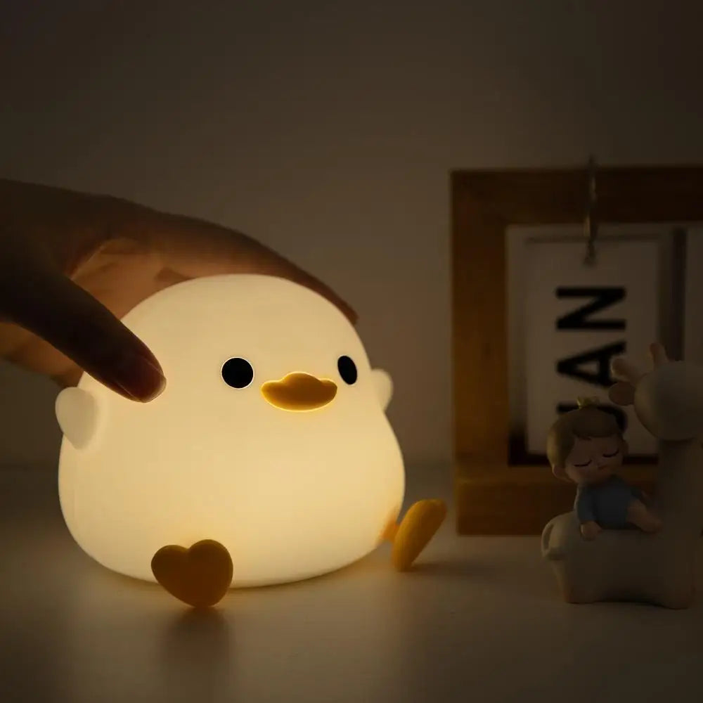 Doudou Duck Night Light providing a soft glow in a child's bedroom